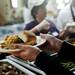 Food is handed out on sustainable plates at St. Frances Church on Friday, March 8. Daniel Brenner I AnnArbor.com